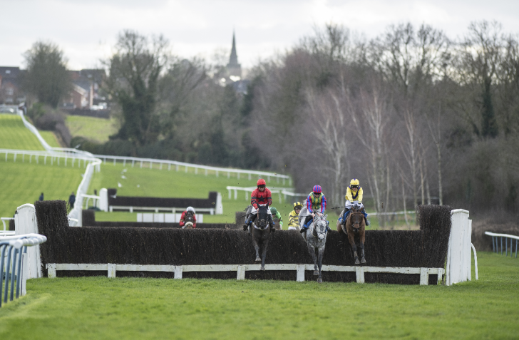 Three runners jumping a fence at Leicester.